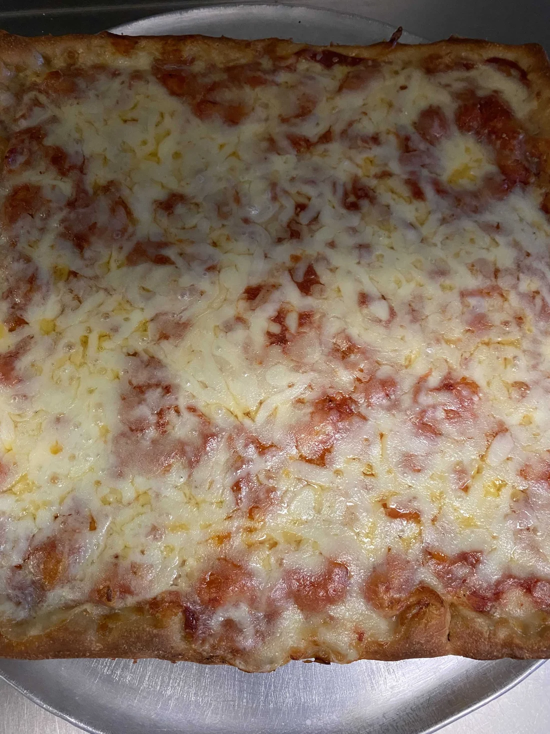 Square Sicilian pizza with melted cheese