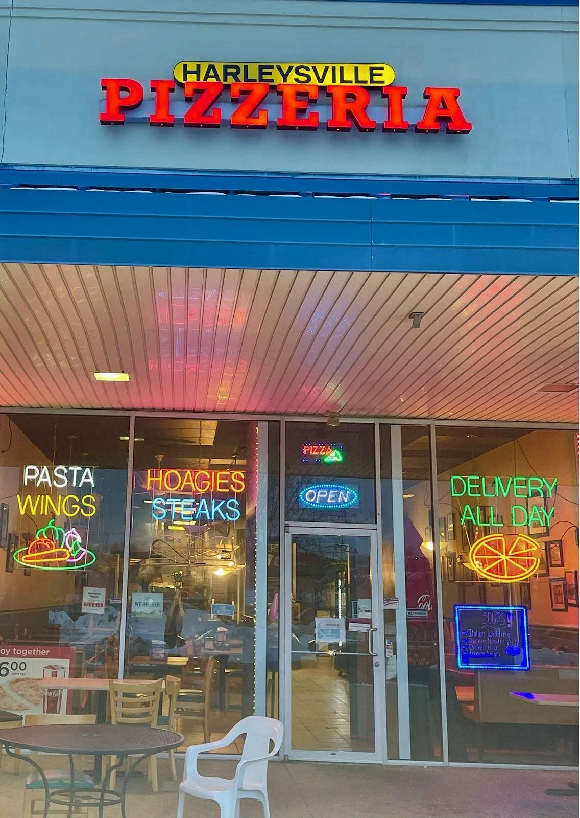 The familiar neon storefront of Harleysville Pizzeria